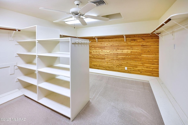 spacious closet with ceiling fan and carpet floors