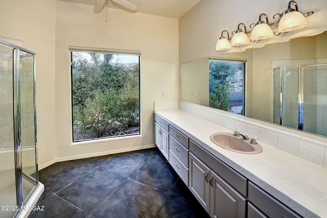 bathroom featuring tile patterned flooring, vanity, an enclosed shower, and ceiling fan