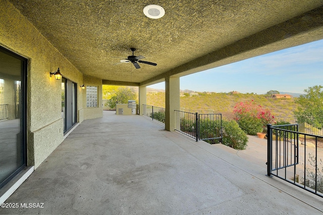 view of patio featuring ceiling fan and a grill