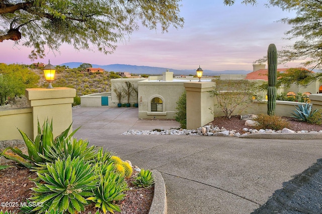 view of front facade featuring a mountain view and a patio