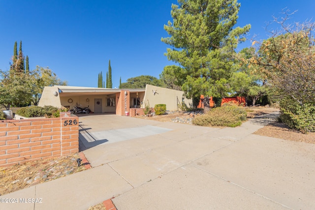 pueblo-style home featuring a carport