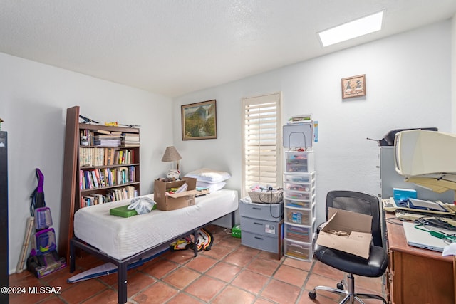 office with tile patterned floors and a textured ceiling