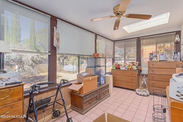 interior space with ceiling fan and a skylight