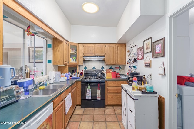 kitchen with white dishwasher, sink, black gas range oven, tasteful backsplash, and washer / dryer