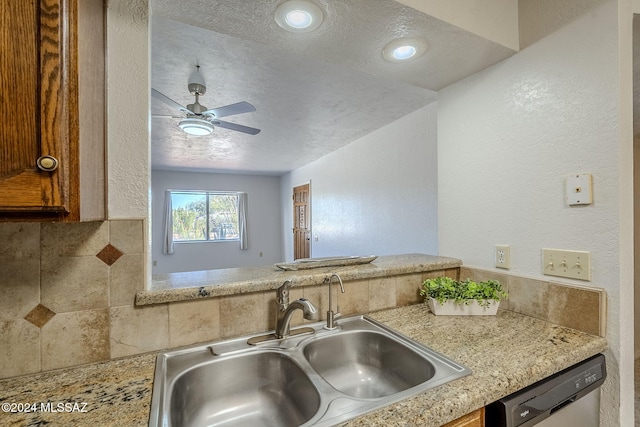 kitchen with tasteful backsplash, a textured ceiling, ceiling fan, sink, and dishwasher