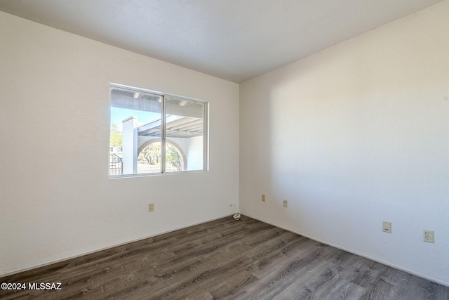 empty room with dark wood-type flooring