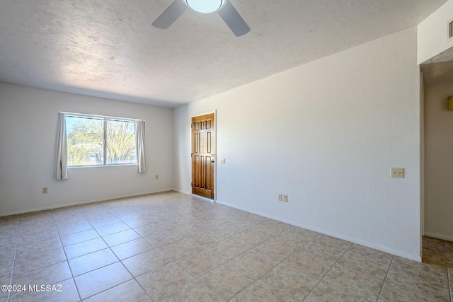 tiled empty room with ceiling fan