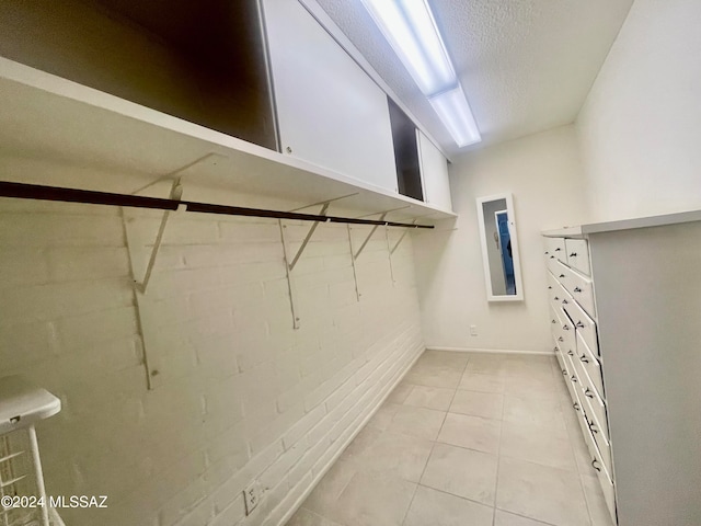 spacious closet with light tile patterned floors