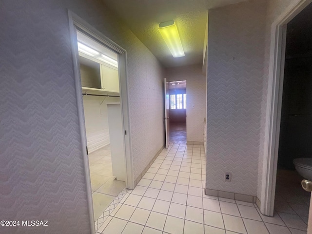 hallway featuring light tile patterned floors