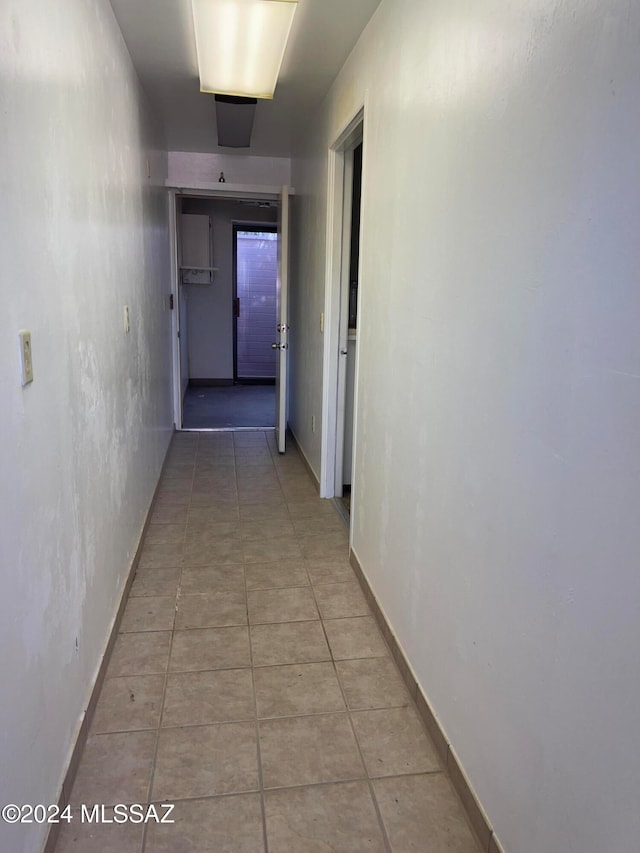 hall with light tile patterned floors