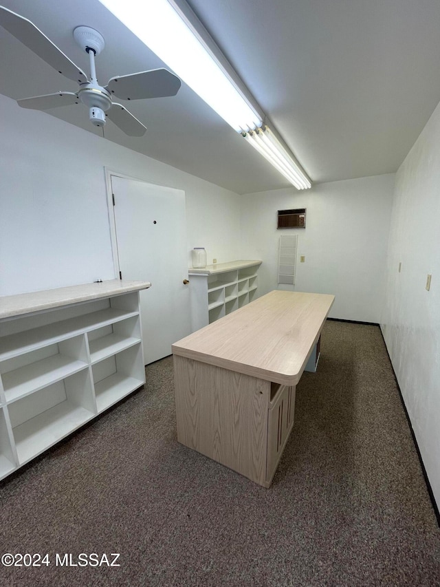 interior space with dark carpet and ceiling fan