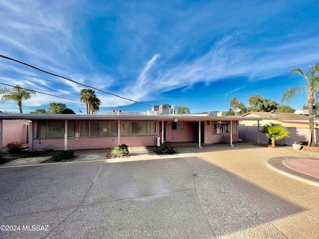 ranch-style house featuring a carport