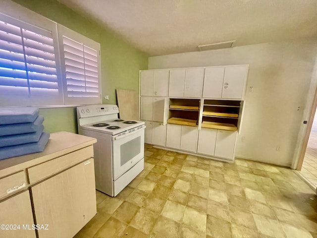 kitchen featuring white range with electric cooktop and white cabinets