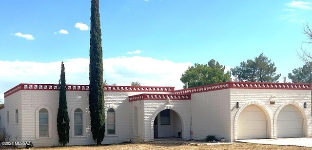 mediterranean / spanish house featuring a garage