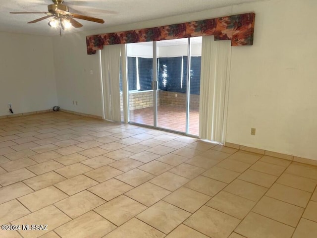 unfurnished room featuring a wealth of natural light, light tile patterned floors, and ceiling fan