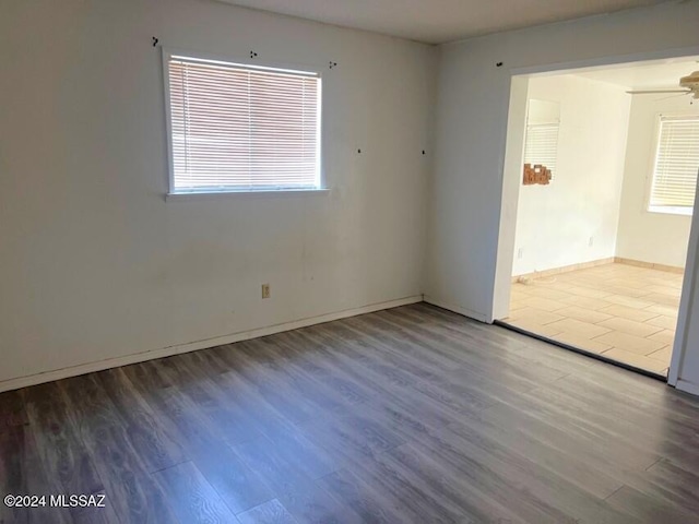 empty room with hardwood / wood-style floors and ceiling fan