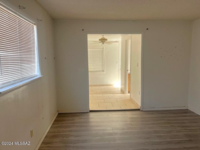 spare room featuring ceiling fan and hardwood / wood-style floors