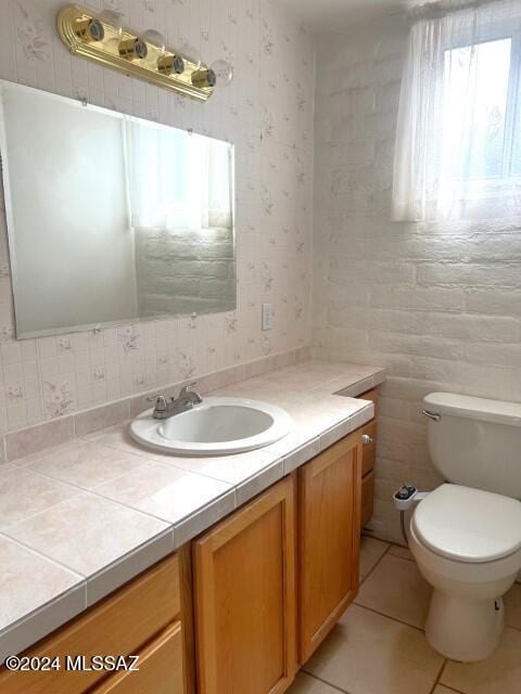 bathroom with tile patterned floors, vanity, and toilet