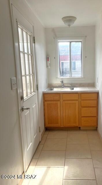 kitchen featuring light tile patterned flooring and sink