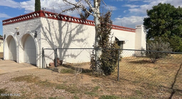 view of side of home featuring a garage