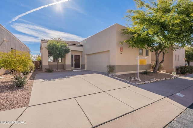 pueblo-style house featuring a garage