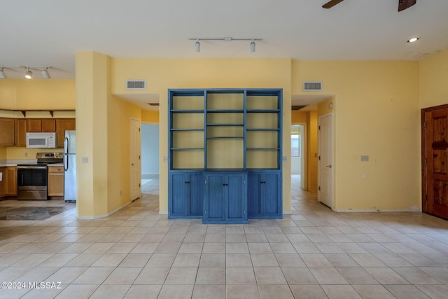 unfurnished living room with light tile patterned floors and ceiling fan