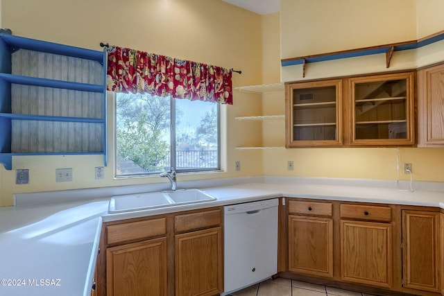 kitchen with sink, light tile patterned floors, and dishwasher