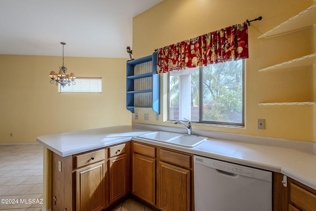 kitchen featuring sink, light tile patterned floors, white dishwasher, kitchen peninsula, and pendant lighting