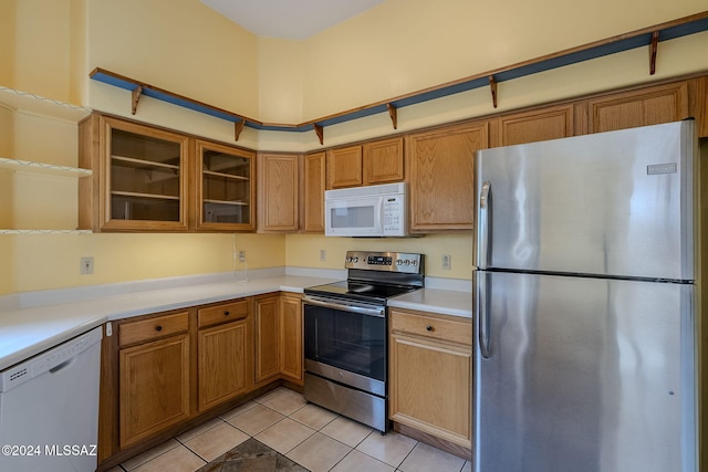 kitchen with light tile patterned floors and appliances with stainless steel finishes