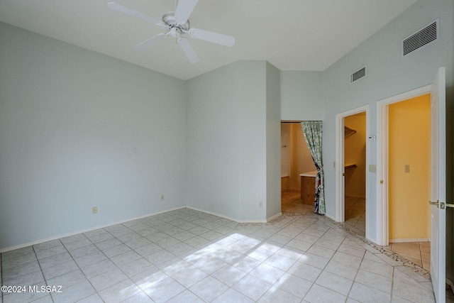 tiled empty room featuring ceiling fan