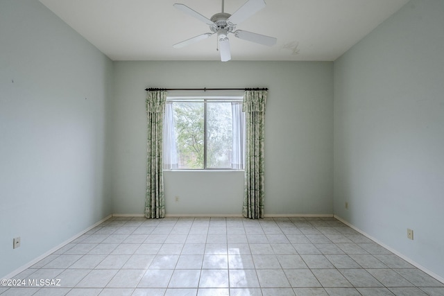 empty room with light tile patterned flooring and ceiling fan