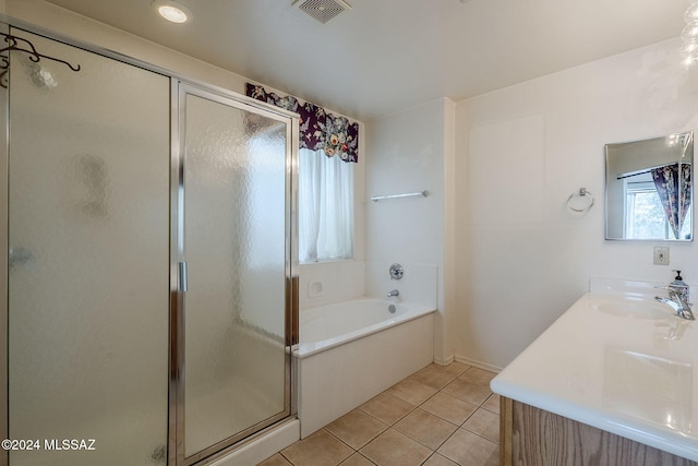 bathroom featuring vanity, plus walk in shower, and tile patterned flooring