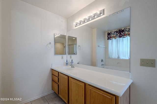 bathroom featuring vanity, tile patterned floors, and a tub