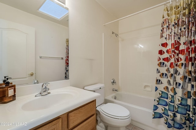 full bathroom with a skylight, vanity, shower / bath combo with shower curtain, and toilet