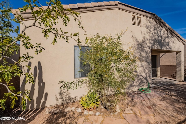 view of side of property featuring a patio area