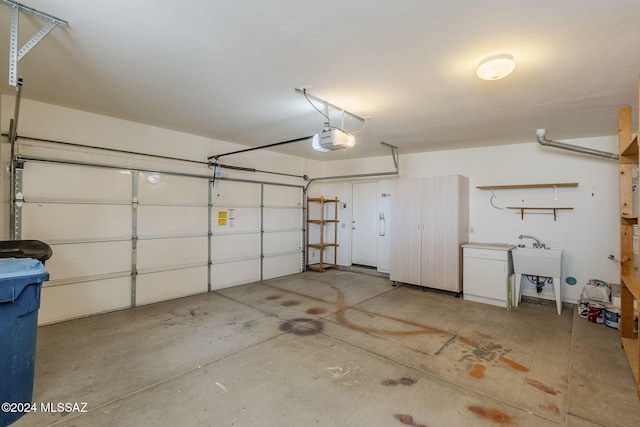 garage with a garage door opener and sink