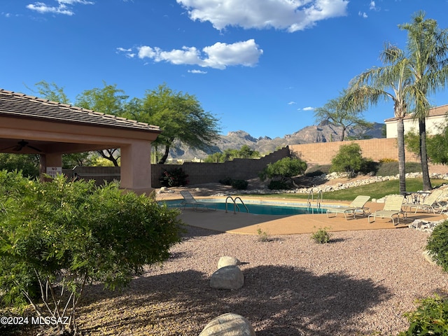 view of pool with a mountain view, a gazebo, a patio area, and ceiling fan