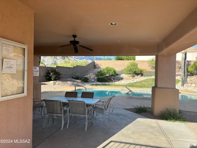 view of patio featuring ceiling fan and a fenced in pool