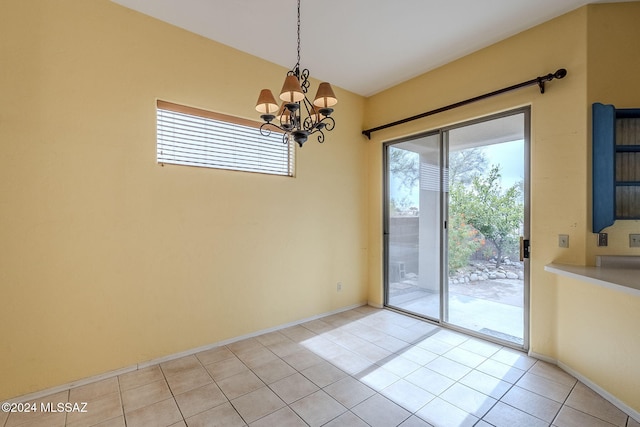 entryway featuring light tile patterned flooring and a chandelier