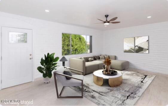 living room with ceiling fan and light wood-type flooring