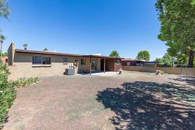 rear view of house with cooling unit and a patio area