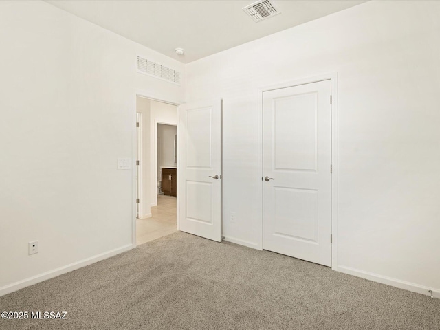 unfurnished bedroom with light colored carpet