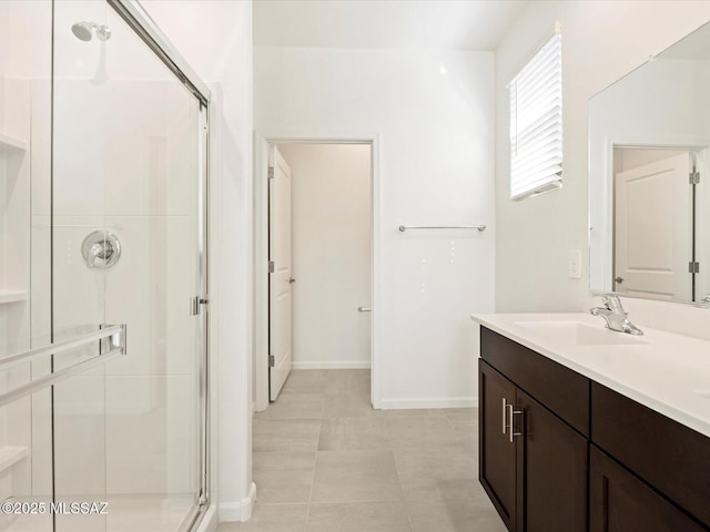 bathroom featuring vanity and a shower with door