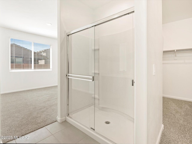 bathroom featuring an enclosed shower and tile patterned floors