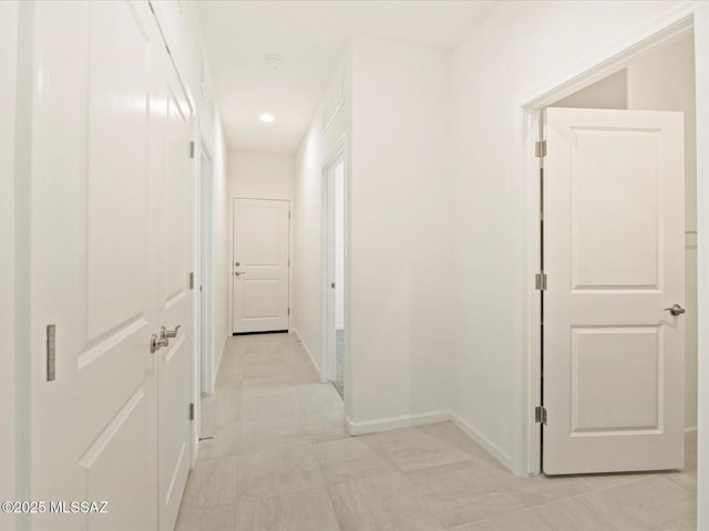 hall with light tile patterned floors