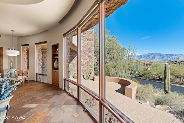 sunroom / solarium with a mountain view and a wealth of natural light