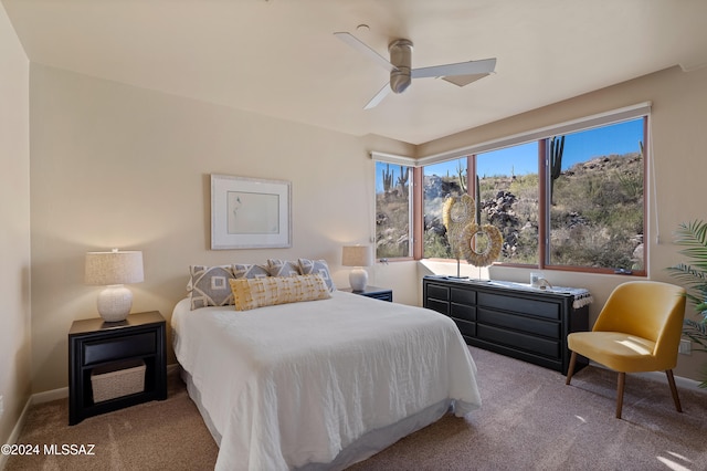 bedroom featuring ceiling fan and light colored carpet