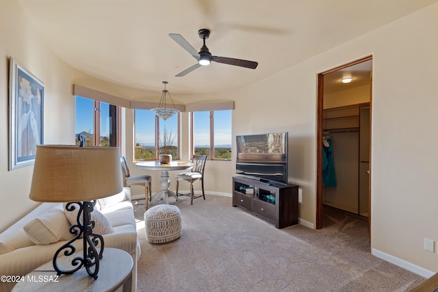 carpeted living room featuring ceiling fan