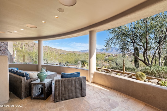 view of patio featuring a mountain view and an outdoor living space