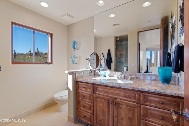 bathroom with tile patterned floors, vanity, toilet, and an enclosed shower